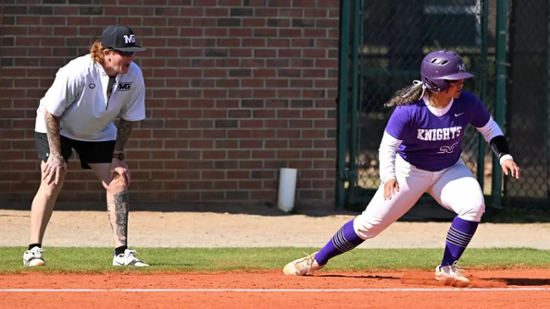 Knights softball player stands on a base during a game.